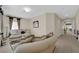 Inviting sitting room featuring a curved sofa, accent pillows, and a decorative mirror at 6739 Quapaw St, Las Vegas, NV 89149