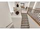Carpeted staircase with a wooden railing and iron balusters leading to an upstairs living area at 6739 Quapaw St, Las Vegas, NV 89149