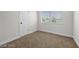 Neutral bedroom with a carpeted floor, a window, and a white door at 728 Carpenter Dr, Las Vegas, NV 89107