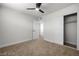 Neutral bedroom with a fan, a closet, a door, and carpeted floors at 728 Carpenter Dr, Las Vegas, NV 89107