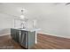 A modern kitchen island with stainless steel dishwasher, sleek countertops, and pendant lighting offers seating space at 728 Carpenter Dr, Las Vegas, NV 89107