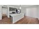 A modern kitchen featuring a large island, stainless steel appliances, and sleek countertops, open to a dining area at 728 Carpenter Dr, Las Vegas, NV 89107