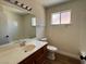 Bathroom featuring a large vanity with a sink, a window, and a tub-shower combo at 8010 Coffee Tree Ct, Las Vegas, NV 89123