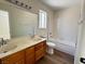 Bathroom features a double sink vanity, shower-tub combo, and wood-look flooring at 8010 Coffee Tree Ct, Las Vegas, NV 89123