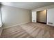 Bright bedroom featuring neutral carpet, a large window, and sliding closet doors at 8010 Coffee Tree Ct, Las Vegas, NV 89123