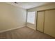Bedroom with plush carpeting, window with blinds, and a sliding door closet at 8010 Coffee Tree Ct, Las Vegas, NV 89123