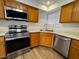 Modern kitchen featuring wooden cabinets, stainless steel appliances, and a bright window at 8010 Coffee Tree Ct, Las Vegas, NV 89123