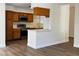 Bright eat-in kitchen with wood cabinets, stainless steel microwave and updated appliances at 8010 Coffee Tree Ct, Las Vegas, NV 89123