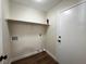 Small laundry room with wood-look floor, single shelf, and hookups at 8010 Coffee Tree Ct, Las Vegas, NV 89123