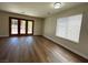 Open living room features modern hard wood floors, large windows, and sliding glass door at 8010 Coffee Tree Ct, Las Vegas, NV 89123