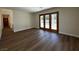 Open floor plan with hardwood floors and glass doors leading to the backyard at 8010 Coffee Tree Ct, Las Vegas, NV 89123