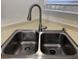 Close-up of stainless steel double basin sink with modern faucet and soap dispenser at 8010 Coffee Tree Ct, Las Vegas, NV 89123