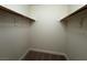 A walk-in closet with carpeted floor and white shelving at 8010 Coffee Tree Ct, Las Vegas, NV 89123