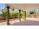 Covered patio with gravel border surrounded by privacy bushes at 8159 Base Camp Ave, Las Vegas, NV 89178
