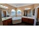 Well-lit primary bathroom with dual sinks, soaking tub, and ample space at 8159 Base Camp Ave, Las Vegas, NV 89178