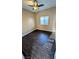Bedroom featuring dark wood flooring, neutral colored walls, and a ceiling fan at 8159 Base Camp Ave, Las Vegas, NV 89178