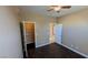 Comfortable bedroom featuring a ceiling fan, closet, wood-look flooring, and ample light at 8159 Base Camp Ave, Las Vegas, NV 89178