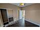 Bedroom with wood flooring, a ceiling fan, a closet, and access to other rooms at 8159 Base Camp Ave, Las Vegas, NV 89178