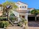 Charming two-story stucco home featuring a red tile roof, desert landscaping, and a brick driveway at 8159 Base Camp Ave, Las Vegas, NV 89178