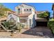 Charming two-story home with stucco siding, a red tile roof, and a brick driveway and desert landscaping at 8159 Base Camp Ave, Las Vegas, NV 89178