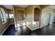 Hallway features dark wood flooring, arched shelving nooks, and neutral colored walls at 8159 Base Camp Ave, Las Vegas, NV 89178
