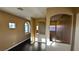 Hallway area with a window and archway to other rooms with wood flooring at 8159 Base Camp Ave, Las Vegas, NV 89178