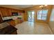 Bright eat-in kitchen features tile floor, dark countertops, and sliding glass door to backyard at 8159 Base Camp Ave, Las Vegas, NV 89178