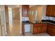 Kitchen area with stainless steel sink, dark countertops and view to stairs at 8159 Base Camp Ave, Las Vegas, NV 89178