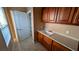 Laundry room featuring tile floors, a sink and cabinets, as well as a pantry at 8159 Base Camp Ave, Las Vegas, NV 89178