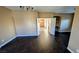 Open-concept living room with dark wood floors and entry to another room at 8159 Base Camp Ave, Las Vegas, NV 89178