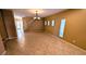 Expansive living space with tile floors, modern lighting, and staircase access to upper level at 8159 Base Camp Ave, Las Vegas, NV 89178