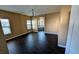 Spacious main bedroom with dark floors, chandelier, and natural light at 8159 Base Camp Ave, Las Vegas, NV 89178