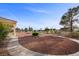 Expansive backyard featuring desert landscaping, walking paths and mature trees at 835 Market Crest Dr, Las Vegas, NV 89110
