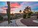 Desert landscaping featuring cactus and mature trees with a paver walkway at 835 Market Crest Dr, Las Vegas, NV 89110