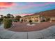 Beautiful property featuring desert landscaping, mountain views, and spacious covered patio at 835 Market Crest Dr, Las Vegas, NV 89110