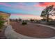 Sunset view of expansive backyard featuring desert landscaping, walking paths and mature trees at 835 Market Crest Dr, Las Vegas, NV 89110