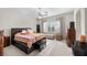 Spacious bedroom featuring a ceiling fan, large window with views, and stylish furnishings and decor at 835 Market Crest Dr, Las Vegas, NV 89110