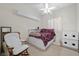 Comfortable bedroom features built-in shelving, and under bed storage. Plush chair and ceiling fan at 835 Market Crest Dr, Las Vegas, NV 89110