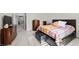 Primary bedroom featuring wood furnishings, a black storage bench, and a plush patterned bedspread at 835 Market Crest Dr, Las Vegas, NV 89110