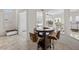 Bright breakfast nook with a round wood table, seating, and lovely views of the outside at 835 Market Crest Dr, Las Vegas, NV 89110
