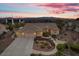 Lovely single-story home featuring a three-car garage, well-manicured landscaping, and inviting curb appeal at dusk at 835 Market Crest Dr, Las Vegas, NV 89110