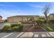 Inviting single-story home showcasing desert landscaping, palm trees, and a three-car garage at 835 Market Crest Dr, Las Vegas, NV 89110