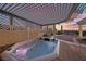 Backyard oasis featuring a hot tub under a pergola, perfect for relaxation with a beautiful sunset at 835 Market Crest Dr, Las Vegas, NV 89110
