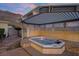 An inviting hot tub under a wooden pergola provides a backyard oasis with mountain views at 835 Market Crest Dr, Las Vegas, NV 89110