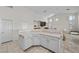 Stylish kitchen with a bar area, white cabinetry, and seamless transition to the living area at 835 Market Crest Dr, Las Vegas, NV 89110
