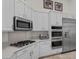 Modern kitchen with white cabinets, stainless steel appliances, and a convenient gas cooktop at 835 Market Crest Dr, Las Vegas, NV 89110