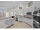 Bright, spacious kitchen with white cabinetry, stainless steel appliances, and tiled floors at 835 Market Crest Dr, Las Vegas, NV 89110