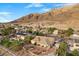 Expansive backyard featuring a covered patio, desert landscaping, and stunning mountain views, perfect for outdoor living at 835 Market Crest Dr, Las Vegas, NV 89110