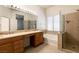 Bright bathroom with dual sinks, soaking tub and glass enclosed shower at 9025 Rusty Rifle Ave, Las Vegas, NV 89143