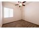 Bedroom with window, ceiling fan, and neutral carpeting at 9025 Rusty Rifle Ave, Las Vegas, NV 89143